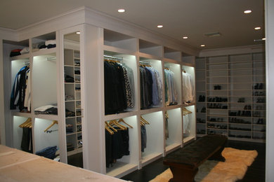Walk-in closet - large modern gender-neutral dark wood floor walk-in closet idea in Miami with open cabinets and white cabinets