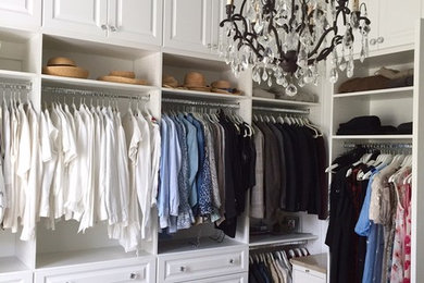 Example of a large transitional gender-neutral walk-in closet design in Other