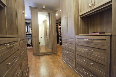 Photo of an expansive classic gender neutral walk-in wardrobe in New York with shaker cabinets and medium hardwood flooring.