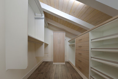 Small nautical walk-in wardrobe for men in Orange County with flat-panel cabinets, light wood cabinets, light hardwood flooring and brown floors.