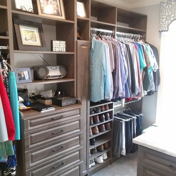 Beautiful Master Closet with island and unique jewelry cabinet