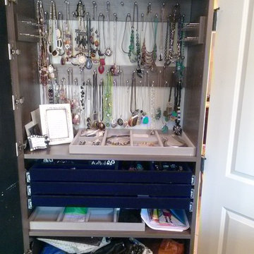 Beautiful Master Closet with island and unique jewelry cabinet