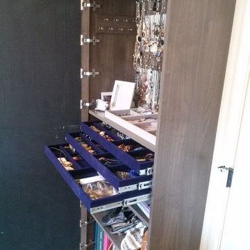 Beautiful Master Closet with island and unique jewelry cabinet