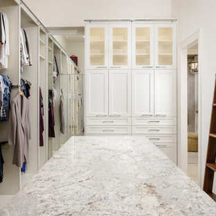 Inspiration for a transitional carpeted and gray floor closet remodel in Houston with glass-front cabinets
