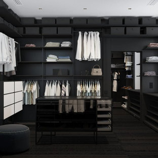 Immagine di una cabina armadio unisex minimalista con ante nere, pavimento con piastrelle in ceramica e pavimento nero