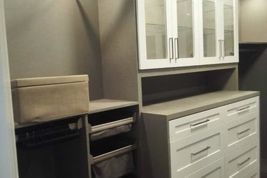 Imagen de armario y vestidor contemporáneo de tamaño medio con armarios estilo shaker, puertas de armario blancas y suelo de madera en tonos medios