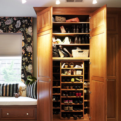 Reach-in closet - traditional reach-in closet idea in DC Metro with raised-panel cabinets and medium tone wood cabinets