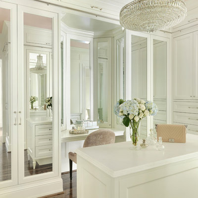 Large elegant women's brown floor and dark wood floor dressing room photo in St Louis with recessed-panel cabinets and white cabinets