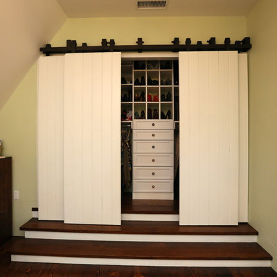 Example of a classic reach-in closet design in Santa Barbara with open cabinets and white cabinets