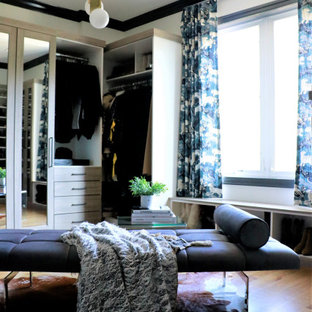 Large minimalist medium tone wood floor dressing room photo in St Louis with gray cabinets