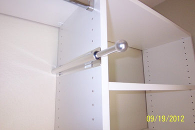 Example of a trendy closet design in Orlando with white cabinets