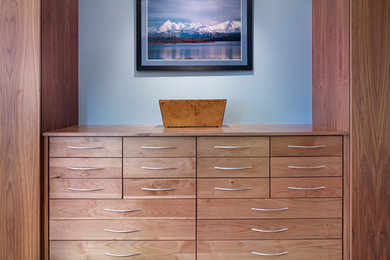 Large trendy gender-neutral carpeted dressing room photo in Denver with flat-panel cabinets and medium tone wood cabinets