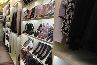 Photo of an expansive modern gender neutral walk-in wardrobe in New York.