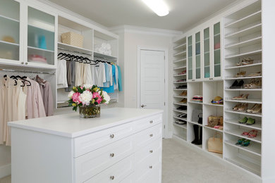 Example of a large beach style women's carpeted walk-in closet design in Other with open cabinets and white cabinets