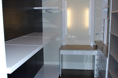 Example of a gender-neutral closet design in Chicago with white cabinets