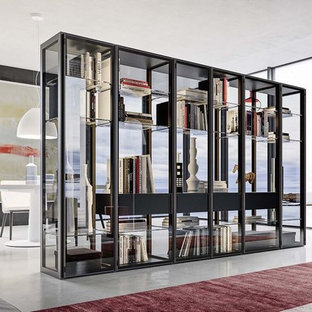 Immagine di un grande armadio o armadio a muro unisex design con ante di vetro, ante nere, pavimento in cemento e pavimento grigio