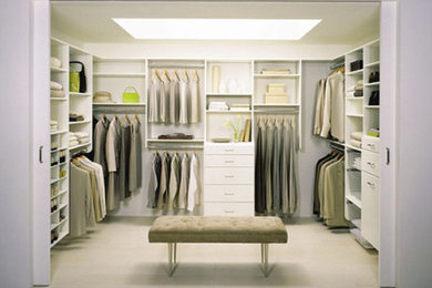 Example of a large trendy gender-neutral carpeted walk-in closet design in Other with open cabinets and white cabinets