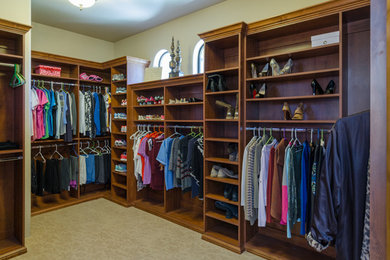 Dressing room - traditional women's carpeted dressing room idea in Phoenix with open cabinets and medium tone wood cabinets