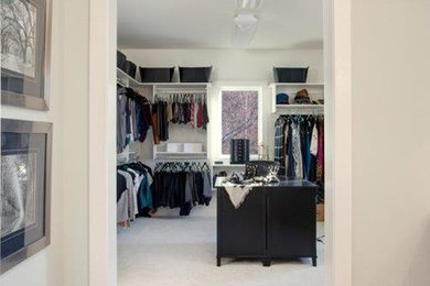 Example of a large classic gender-neutral walk-in closet design in Other