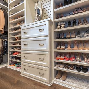 Large transitional women's dark wood floor and brown floor dressing room photo in Houston with recessed-panel cabinets and white cabinets