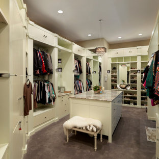 Réalisation d'un grand dressing design pour une femme avec un placard à porte plane, des portes de placard blanches, moquette et un sol violet.