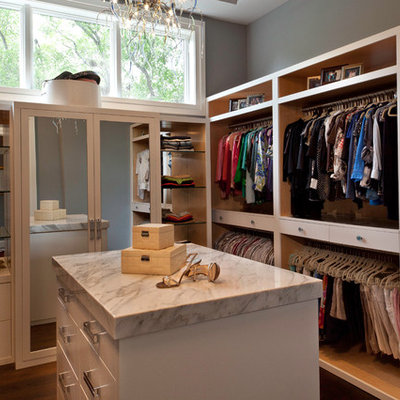 Trendy women's medium tone wood floor dressing room photo in Miami with open cabinets