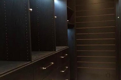 Medium sized contemporary gender neutral walk-in wardrobe in New Orleans with open cabinets and dark wood cabinets.