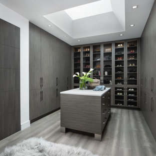 Example of a trendy brown floor dressing room design in Detroit with flat-panel cabinets and dark wood cabinets