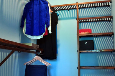 Ejemplo de armario vestidor unisex clásico de tamaño medio con puertas de armario de madera oscura y moqueta