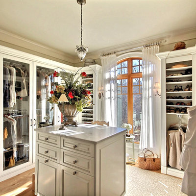 Elegant light wood floor dressing room photo in Atlanta with white cabinets