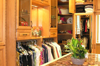 Walk-in closet - large traditional men's walk-in closet idea in St Louis with raised-panel cabinets and light wood cabinets