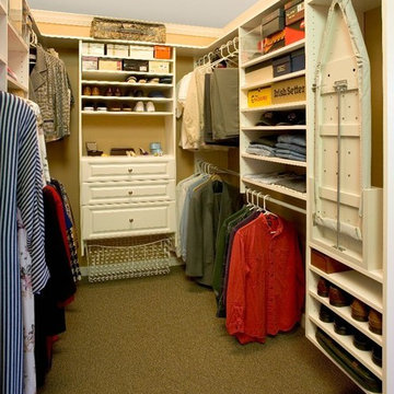 Custom closet with lots of double hang space and an ironing board