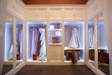 Inspiration for a large women's dressing room remodel in Miami with flat-panel cabinets and white cabinets
