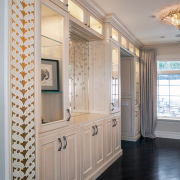 Custom Couture Master Closet with White Raised Panel Cabinetry and Gold Paint