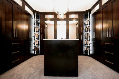 Example of a huge trendy gender-neutral carpeted and gray floor walk-in closet design in Other with shaker cabinets and dark wood cabinets