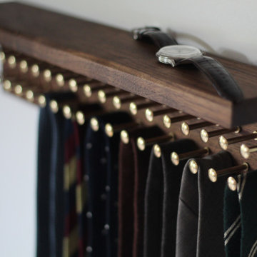 Custom walnut tie rack with brass pegs