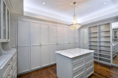 Inspiration for a large timeless gender-neutral carpeted walk-in closet remodel in Philadelphia with raised-panel cabinets and white cabinets