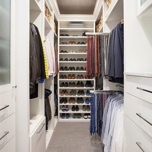 Example of a mid-sized transitional gender-neutral carpeted and brown floor walk-in closet design in Dallas with flat-panel cabinets and white cabinets