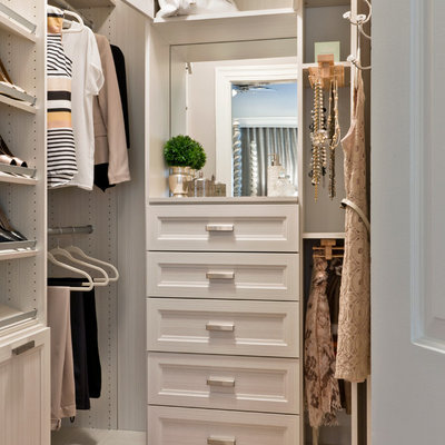 Transitional women's medium tone wood floor walk-in closet photo in Other with recessed-panel cabinets and white cabinets