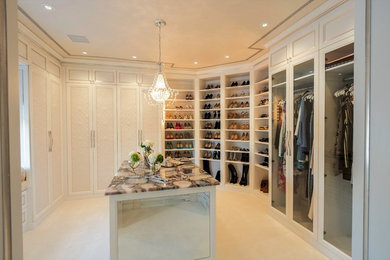 Walk-in closet - large transitional women's walk-in closet idea in New York with recessed-panel cabinets and white cabinets