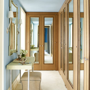 Transitional carpeted and beige floor dressing room photo in New York with recessed-panel cabinets and medium tone wood cabinets