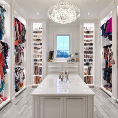 Walk-in closet - traditional gray floor walk-in closet idea in Houston with beaded inset cabinets and white cabinets