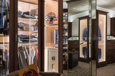 Example of a large minimalist gender-neutral carpeted and gray floor walk-in closet design in San Diego with raised-panel cabinets and dark wood cabinets