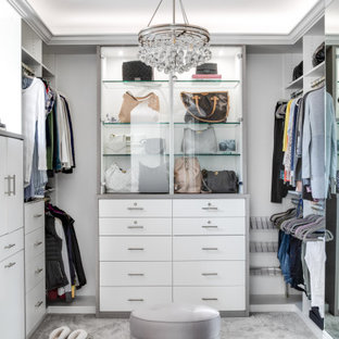 Mid-sized tuscan women's carpeted and gray floor walk-in closet photo in Los Angeles with flat-panel cabinets and white cabinets