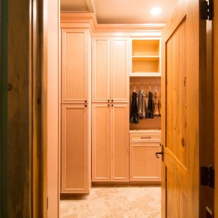 Foto de armario vestidor unisex, clásico, grande, con armarios con paneles con relieve, puertas de armario de madera clara, suelo de travertino y suelo beige