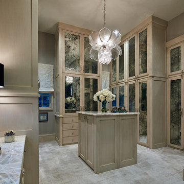 Expansive Woman's Closet with Vanity and Glass Front Custom Cabinets