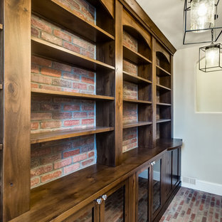 Inspiration for a large timeless gender-neutral brick floor walk-in closet remodel in Denver with shaker cabinets and medium tone wood cabinets