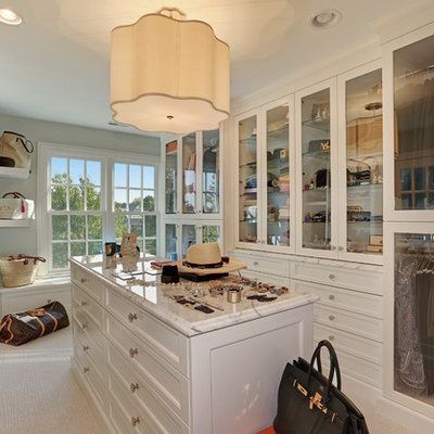 Inspiration for a huge timeless women's carpeted and beige floor walk-in closet remodel in Chicago with white cabinets and glass-front cabinets