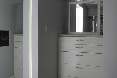 トロントにある小さなコンテンポラリースタイルのおしゃれなウォークインクローゼット (シェーカースタイル扉のキャビネット、白いキャビネット、トラバーチンの床) の写真