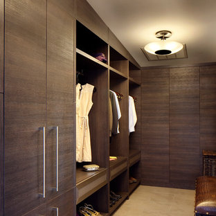 Large trendy gender-neutral travertine floor dressing room photo in Other with flat-panel cabinets and dark wood cabinets